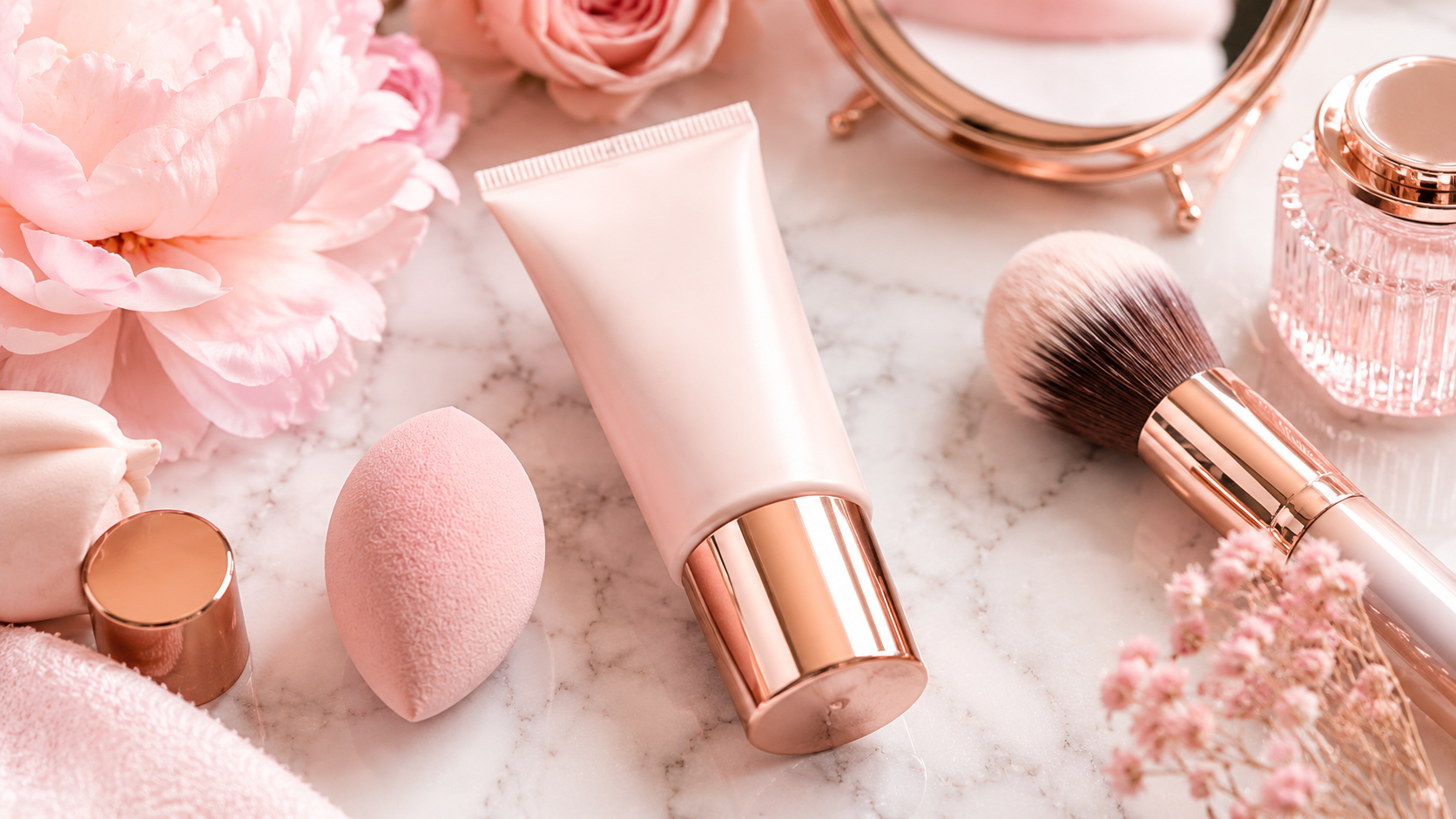 Primer before makeup with soft pink makeup primer and beauty tools